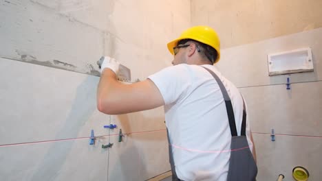 closeup of laying ceramic tiles on the floor master builder installs tiles