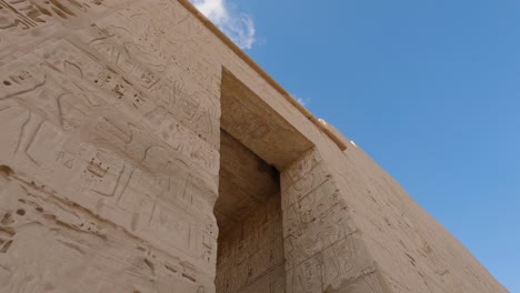 Low-angle-view-of-the-entrance-to-Medinet-Habu-temple-near-Luxor,-Egypt