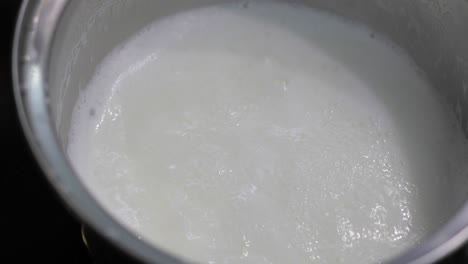 Adding-flakes-to-pot-with-boiling-milk.-High-energy-morning-food