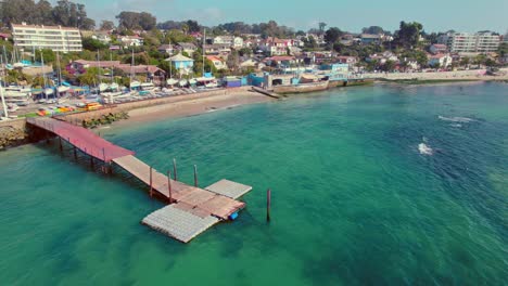 coast dock at el pejerrey beach algarrobo chile aerial view above blue sea water in resort holiday destination at south america, summer vibes