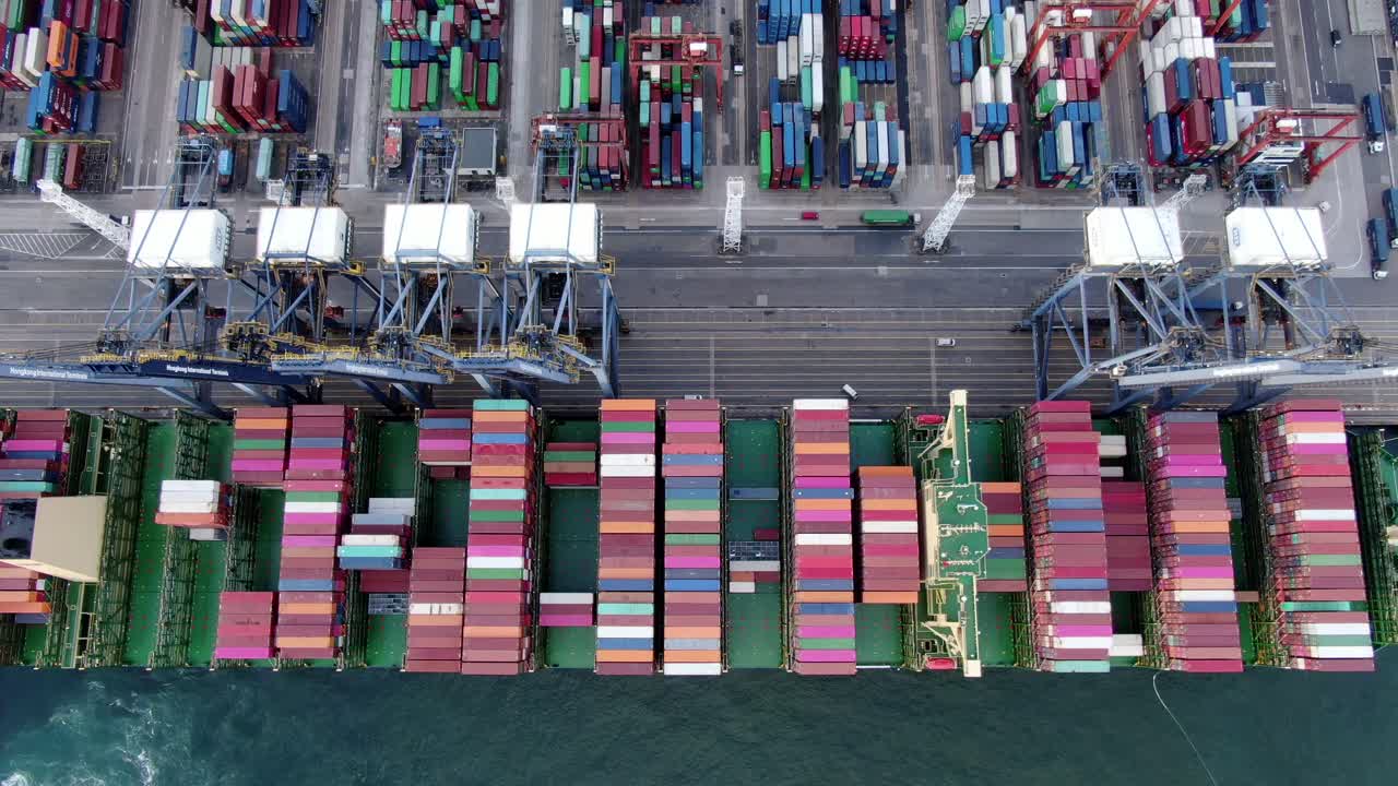 Mega Container Ship docked at Hong Kong port, during loading and unloading operation, Aerial view