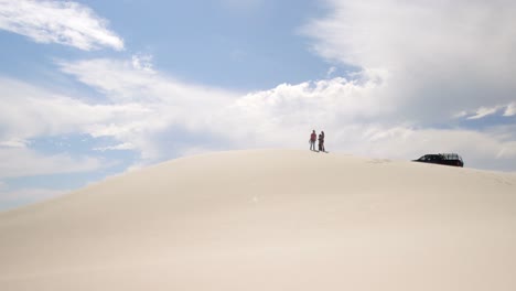 couple standing on the sand dune in desert 4k