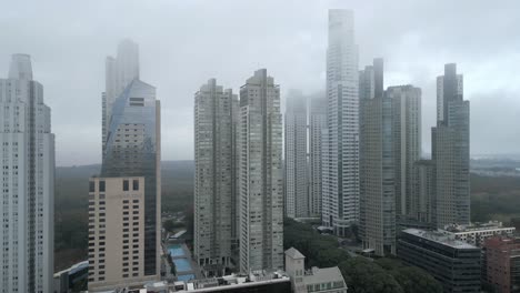 drone shot of skyscrapers of puerto madero under the fog, high-rise apartment buildings and luxury hotels, buenos aires, argentina