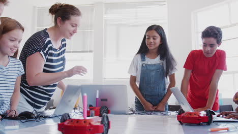 Estudiantes-Emocionados-Viendo-Moverse-El-Vehículo-Robot-Después-De-Una-Lección-De-Codificación-En-Clase-De-Programación-Informática