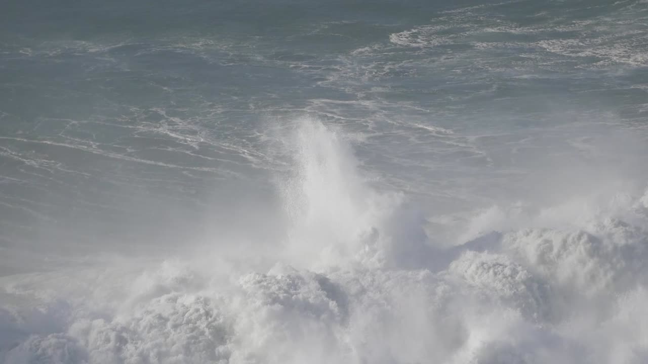 Massive waves crashing at Nazare, Portugal, capturing the force of the ocean's power
