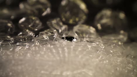 pushing into a bubble wrap bag, top details - textures of the bubbles are visible