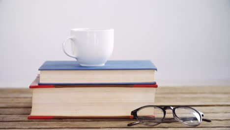 books, coffee cup and spectacles on wooden table 4k