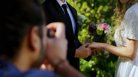 Groom-holding-bride-hand-and-photographer-taking-photo-4K-4k