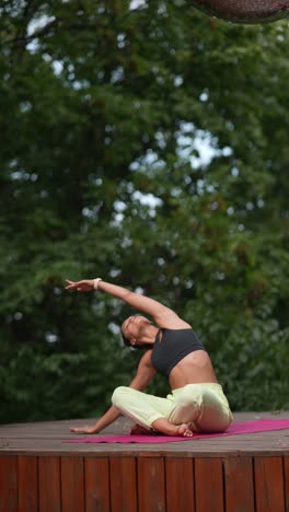 woman practicing yoga outdoors