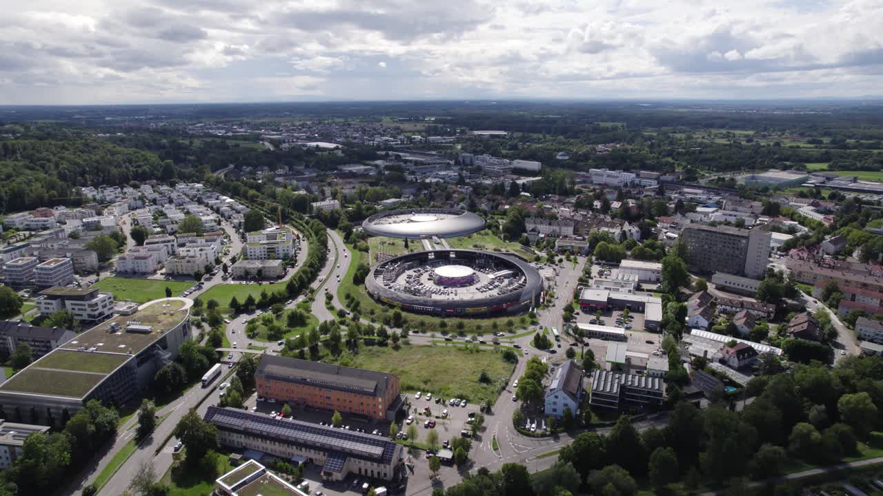 Aerial view orbiting colourful Baden Baden Gewerbepark modern shopping Cit&eacute; futuristic skyline