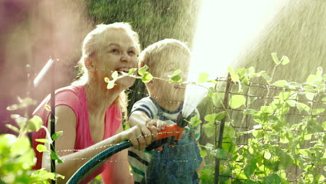 mom and son watering the garden together