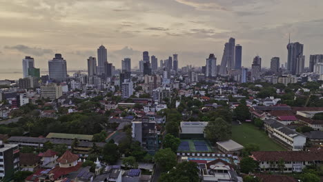 Colombo-Sri-Lanka-Aerial-v30-low-flyover-Bambalapitiya-and-Kollupitiya-neighborhoods-capturing-upscale-homes-and-downtown-cityscape-of-Wekanda-and-Fort-at-sunset---Shot-with-Mavic-3-Cine---April-2023