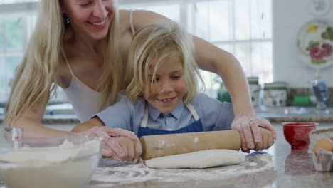 mother and son making christmas cookies at home