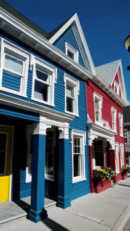 vibrant houses and a person on a sunny street