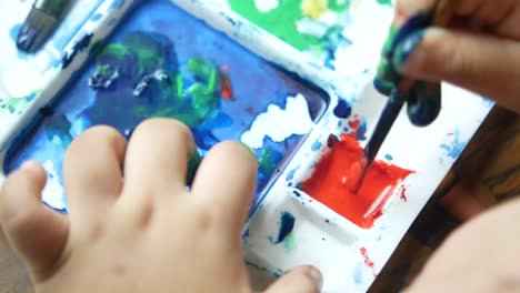 child painting with watercolors