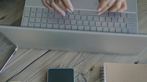 persona escribiendo en una computadora portátil en un escritorio