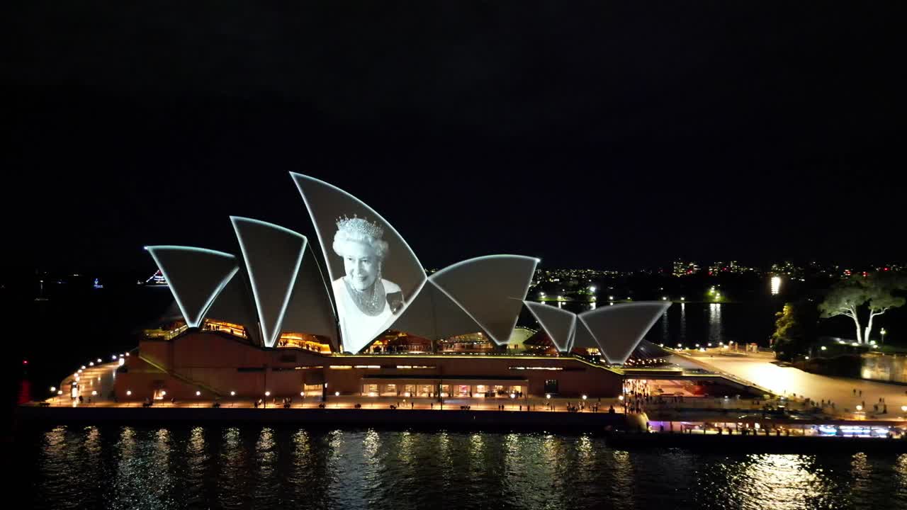Sydney Opera House projects a memorial for the passing of Queen Elizabeth II, Britain's longest-reigning monarch who died aged 96. Drone pushes into Queen projected onto the sails.