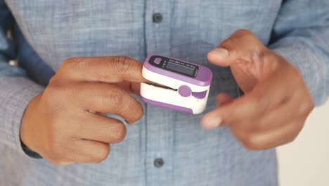 a man using a finger pulse oximeter