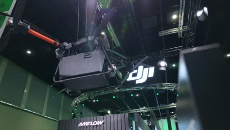 dji flycart30 aerial delivery drone hanging at ifa exhibit in berlin, germany. low angle shot