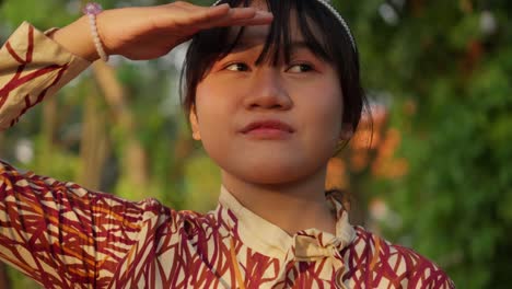 happy indonesian girl enjoying sunshine with her hands