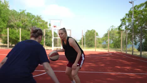 women playing basketball outdoors