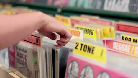 hand selecting vinyl record from market stall