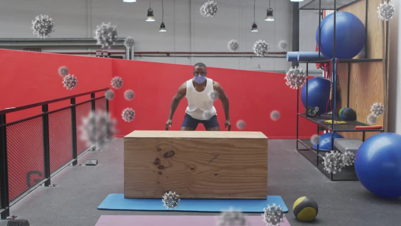 Man doing box jumps on wooden plyo box, initiating via knee bend, fitness, virus overlay drifting