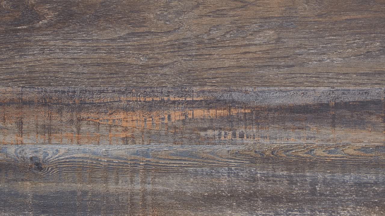 Macro pan reveals worn tabletop grain and deep rustic marks