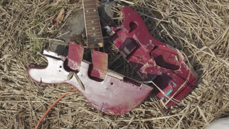 broken guitar parts on the ground