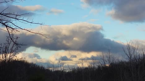 low angle shot of big clouds in the blue sky during the winter time