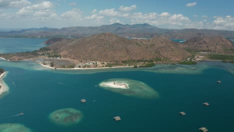 aerial of lombok shore with traditional floating fishermen instruments in bay