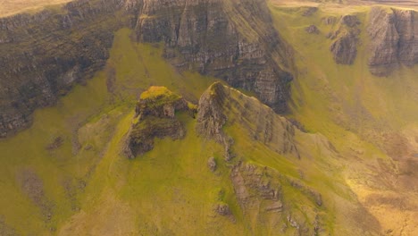 Aerial drone footage of the dramatic mountain landscapes on the Isle of Skye, Scotland. Sweeping panoramic views of majestic peaks, green valleys, and wild nature