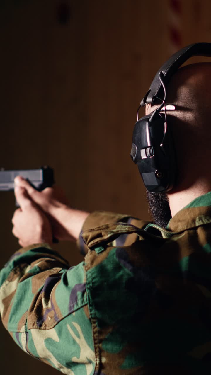 Vertical video Excited soldier training with weapon thrilled after accurately hitting bullseye