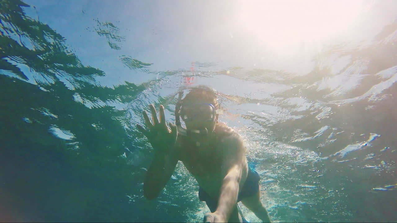 Sunlight Illuminates A Man In A Mask For Scuba Diving