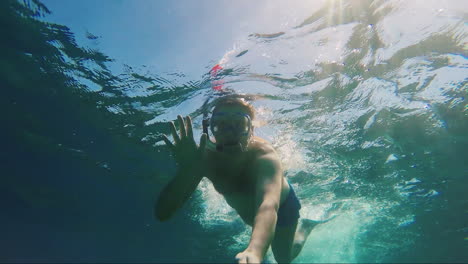 sunlight illuminates a man in a mask for scuba diving