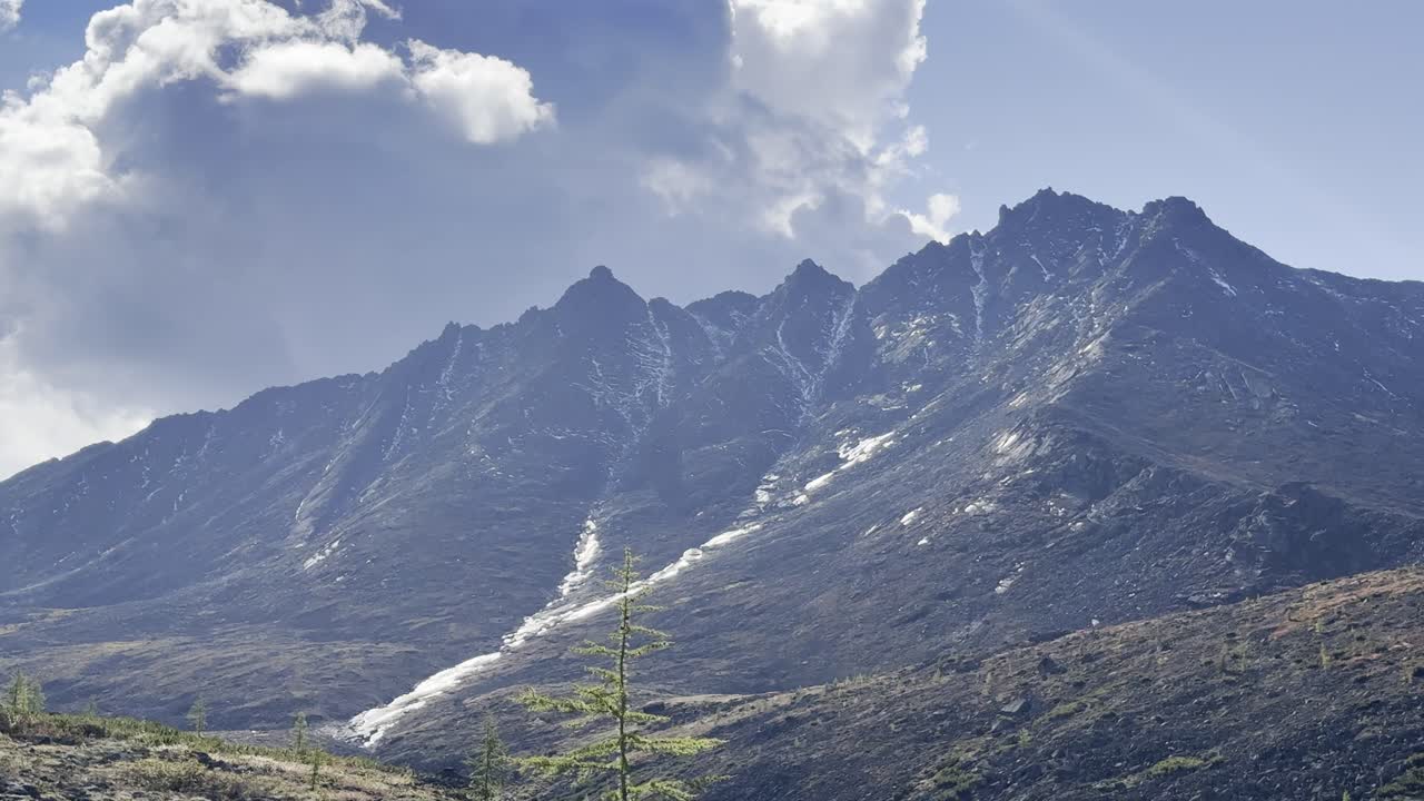 Majestic mountain panorama with clear blue sky and fluffy clouds