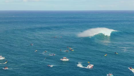 courageous young surfers paddle close to big ocean waves trying to find right moment for riding wave in hawaii