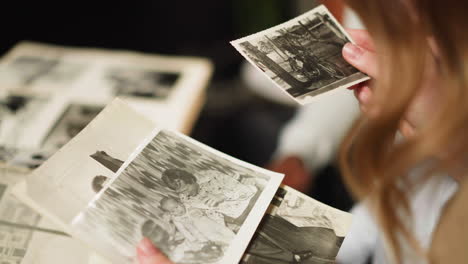 woman with little daughter and husband looks at old pictures