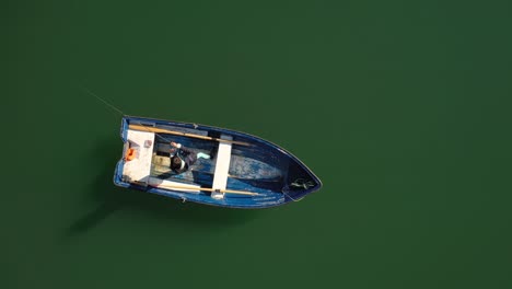 woman on the boat catches a fish on spinning in norway.