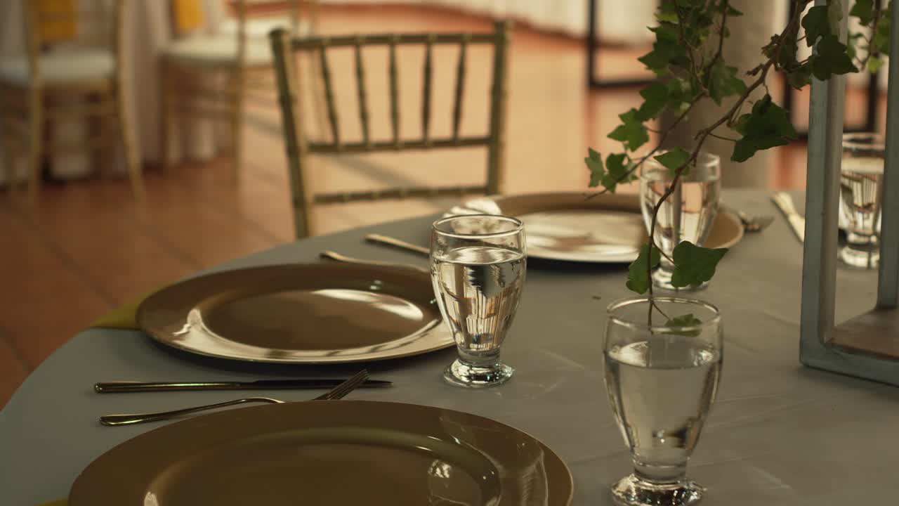 Hall with tables decorated for wedding reception with fresh flowers. Banquet table.