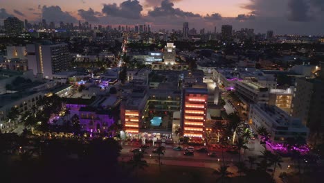 colorful art deco buildings along ocean drive, south beach miami, dusk drone shot