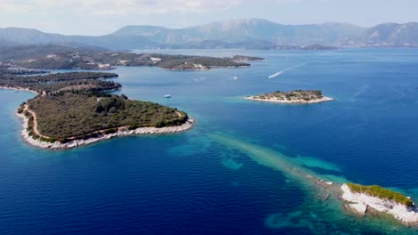 meganisi island, lefkas, greece - aerial drone view of boats, jetski, mountains and blue sea