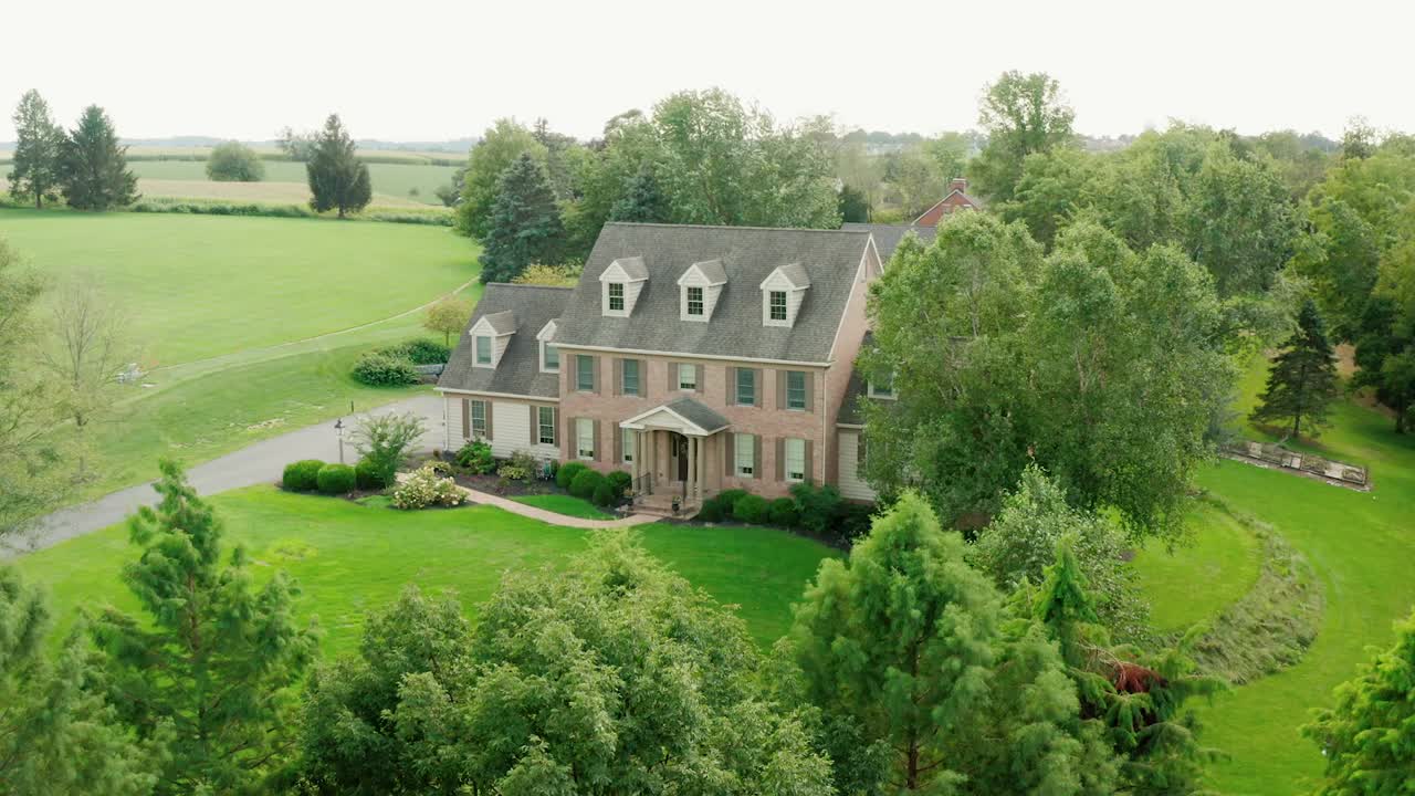 Three story red brick mansion in rural America