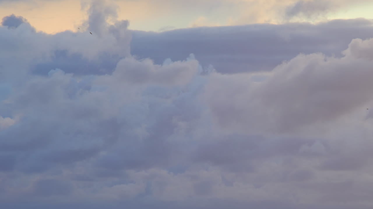 timelapse of clouds with blue, grey, white, yellow colours