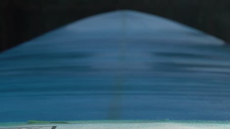 close up slow motion shot of spray painting surfboard