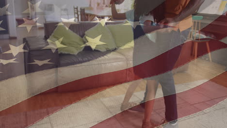 animation of flag of usa waving over african american father dancing with daughter