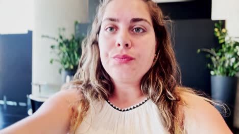 young woman speaking to the camera while vlogging