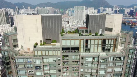 Aerial-shot-of-Downtown-Hong-Kong-mega-residential-skyscrapers-and-traffic,-on-a-beautiful-day