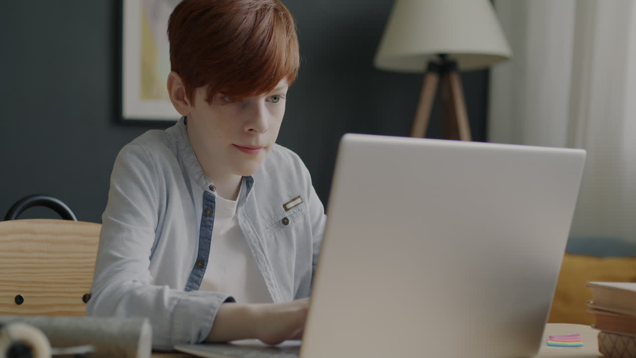 Teenage Boy Studying on Laptop