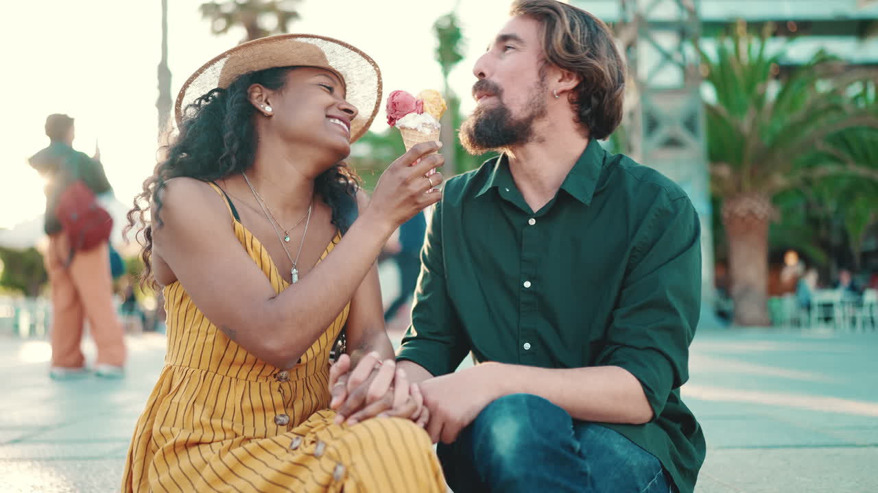 A couple shares an ice cream on a sunny day